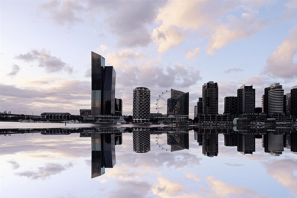 Docklands towers and the Melbourne Star reflected in Victoria Harbour