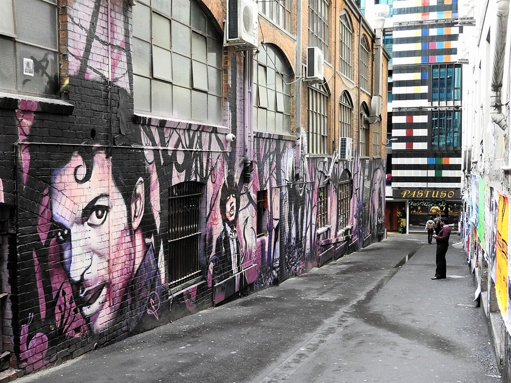 Large painted murals of musicians along AC/DC Lane