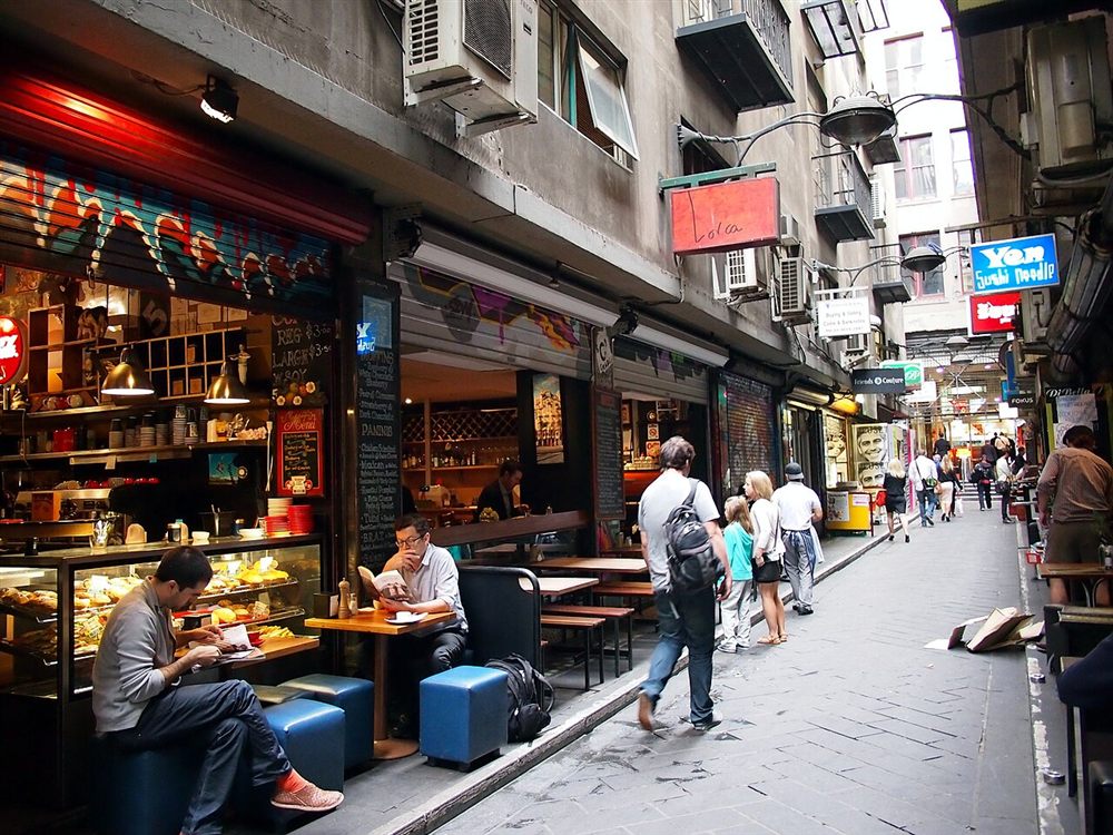 People eating at a tiny café in the narrow Centre Place laneway