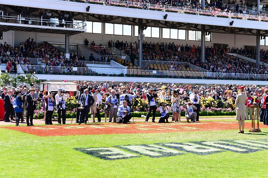 Crowds and photographers in front of the grandstand at Flemington on Melbourne Cup day