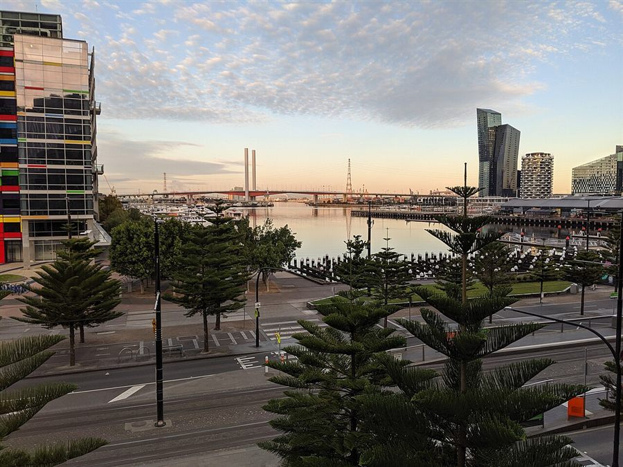 Victoria Harbour's waterfront and the Bolte Bridge in early morning light