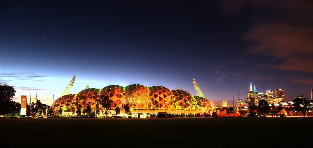 AAMI Park's domed roof glowing orange at night